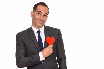 Mature Persian businessman holding heart ready for Valentine's day