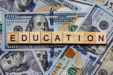 The word education on dollar usa background. College credits, graduation funds, tuition money concept. - 317534094