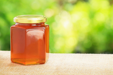 Honey from nature pollen flower in glass bottle.