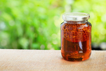 Honey from nature pollen flower in glass bottle.
