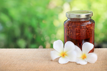 Honey from nature pollen flower in glass bottle.