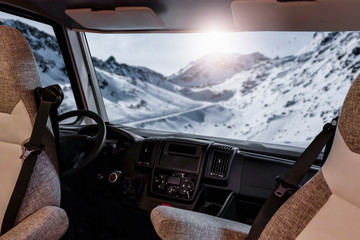 Winter camper with big window and free space for your decoration.Mountains with sun light and snow...