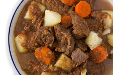 Irish beef stew with carrots and potatoes isolated on white background. Close up	
