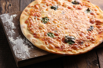 Italian cuisine. Pizza on a wooden background
