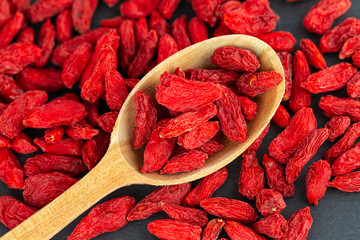 goji berries in wooden spoon. Top view, flat lay