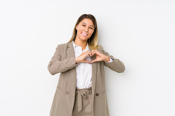 Young caucasian business woman isolated smiling and showing a heart shape with hands.