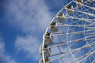 White Ferris Wheel Over Blue Sky in the sunny day