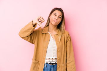 young caucasian woman posing isolated showing a dislike gesture, thumbs down. Disagreement concept.