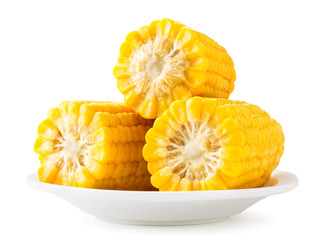 Boiled corn slices close-up on a white background in a plate slide. Isolated