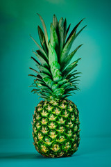 Tropical summer background. Pineapple on a blue background. Food concept. Minimal.