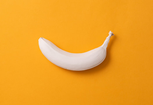 Abstract image of a white banana on a yellow background. minimalism concept
