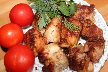 Roast pork with herbs and tomatoes on a plate