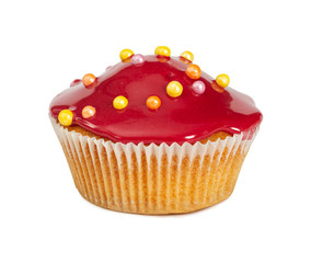 Muffin with red glossy glaze and colored sprinkles