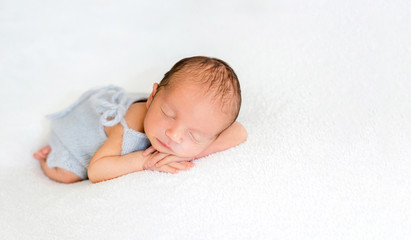 Cute newly arrived baby lying, wrapped in blanket