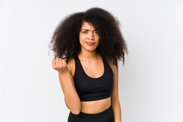 Fototapeta na wymiar Young african american sporty woman showing fist to camera, aggressive facial expression.