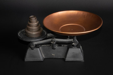 Antique Scale and weights  on black background
