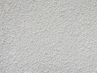 White stucco wall with large bump texture.