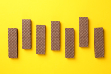 Flat lay with wafers on yellow background, top view