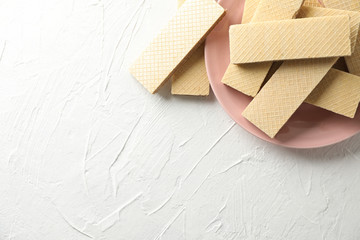 Plate with sweet wafers on white background, space for text
