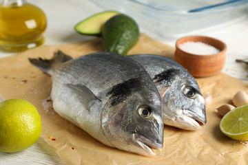 Baking paper with tasty dorado fish, close up 
