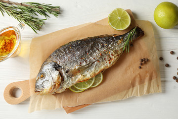 Baking paper with tasty dorado, top view 