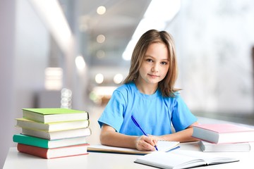 Little beautiful child learning in a classroom