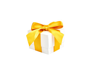 Handmade white paper box with yellow gold satin ribbon and bow on an isolated white background.