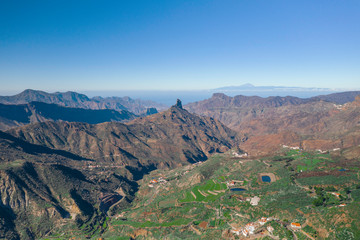 Scenic cinematic aerial view of Pico de las Nieves - the highest peak on the island of Gran Canaria on Canary Islands in Spain. Beautiful summer sunny look of mountains of islands in Athlantic ocean