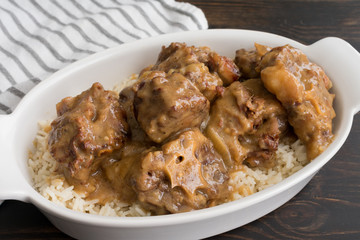 Southern Smothered Oxtails: Traditional Southern beef oxtails smothered in onion gravy and served over white rice
