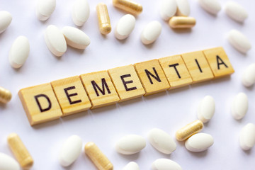 The medical phrase dementia on different pills and capsules background. Pharmacy theme, health care, drug prescription for treatment medication and medicament.