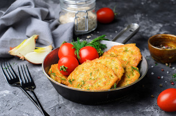 Oatmeal Fritters in a Frying Pan over Dark Background