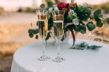 Two glasses of champagne at wedding decorated table