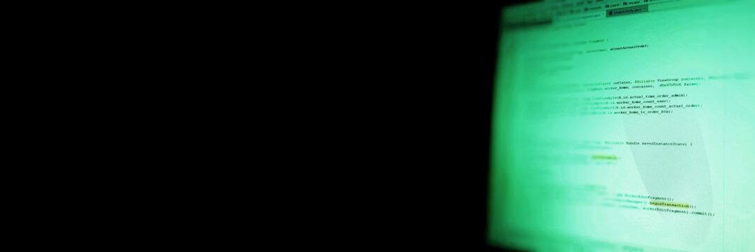  Banner with black space for design and your text. Android mobile development. Application source code on notebook green screen background.