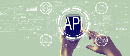 API - application programming interface concept API concept with person holding a white smartphone