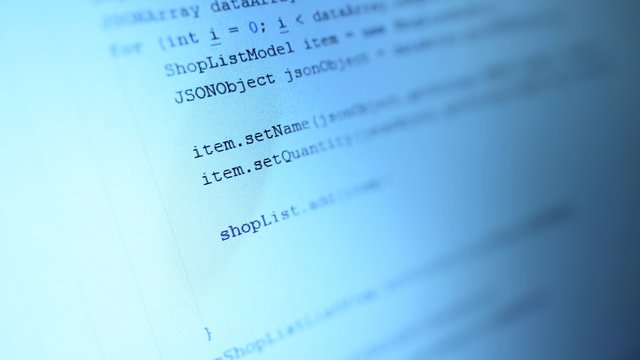  Android mobile development. Application source code on notebook blue screen background.  Software developer programming code on computer. Abstract computer script source code.