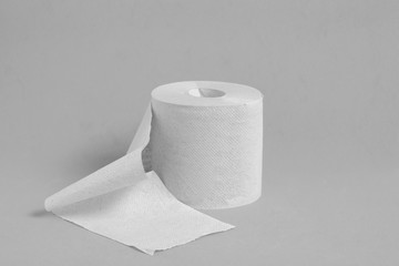 Roll of toilet paper on a gray background.