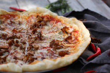 Italian cuisine. Pizza on a wooden background, rustic style