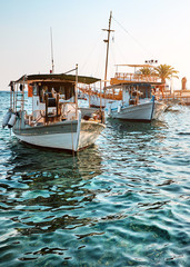 Authentic fishing boats by pier in Neos Marmaras small town on Peninsula Sithonia, Chalkidiki,...