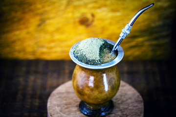 Gaucho yerba mate tea, the chimarrão, a typical Brazilian drink, traditionally in a bombilla stick cuiade gourd against a wooden background. Rio Grande do Sul, favorite drink of the gauchos.