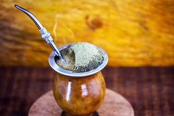 Gaucho yerba mate tea, the chimarrão, a typical Brazilian drink, traditionally in a bombilla stick cuiade gourd against a wooden background. Rio Grande do Sul, favorite drink of the gauchos.