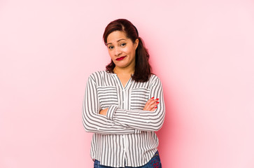 Middle age latin woman isolated on a pink background unhappy looking in camera with sarcastic...