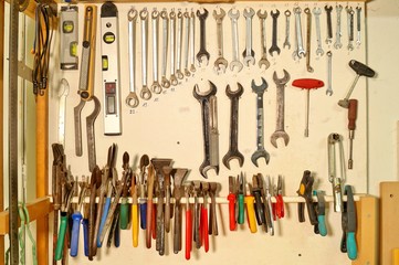Collection of work tools. Working tools. Hand Tools in the workshop on wooden wall. woodworking, craftsmanship and handwork concept. Repair and construction tools collection. Tongs, Pliers and pincers