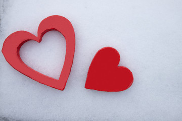 Love and Valentines: love hearts. A pair of red wooden carved hearts isolated on white