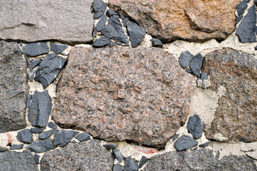 Stone structure from large fragments of granite close-up.
