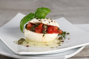 Mozzarella stuffed tomatoes with capers