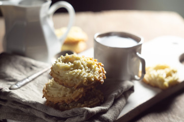 Shortbread cookies on a linen napkin and a cup of coffee