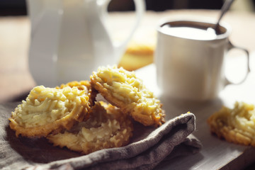 Shortbread cookies on a linen napkin and a cup of coffee