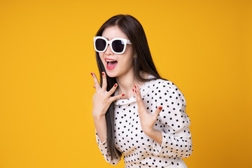 Fototapeta premium Asian woman in summer casual clothes.She smiling and happy shopping bags. she lovely attractive shine on yellow background.Summer Surprise Sale concept.