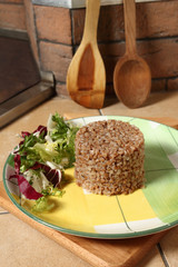 Cooked buckwheat porridge with salad on plate