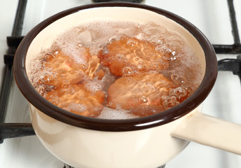 Boiling eggs in saucepan on gas stove